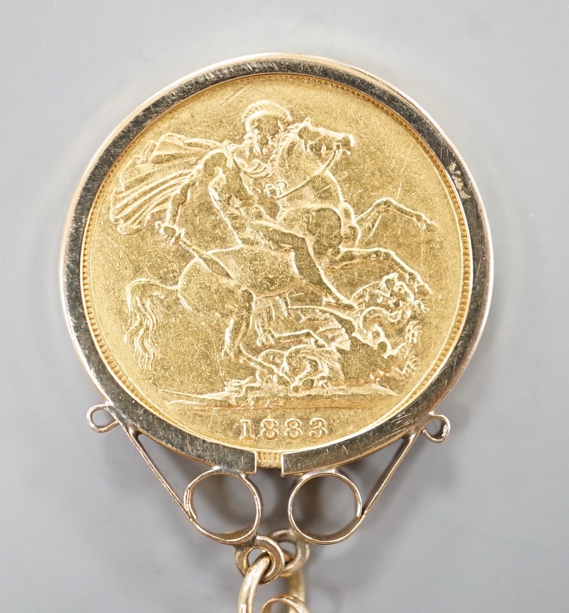 A Victoria 1883 gold sovereign, in a later 9ct gold pendant mount, on a 9k chain